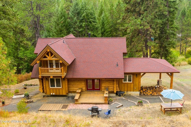 26443 S Farup Rd, Worley, ID 83876 - rear view of property featuring french doors, a wooden deck, and a forest view