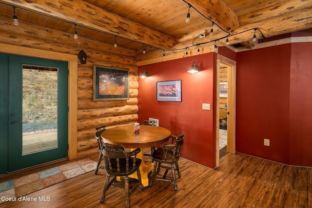 26443 S Farup Rd, Worley, ID 83876 - dining area with a wooden ceiling with exposed beams, rustic walls, and wood finished floors