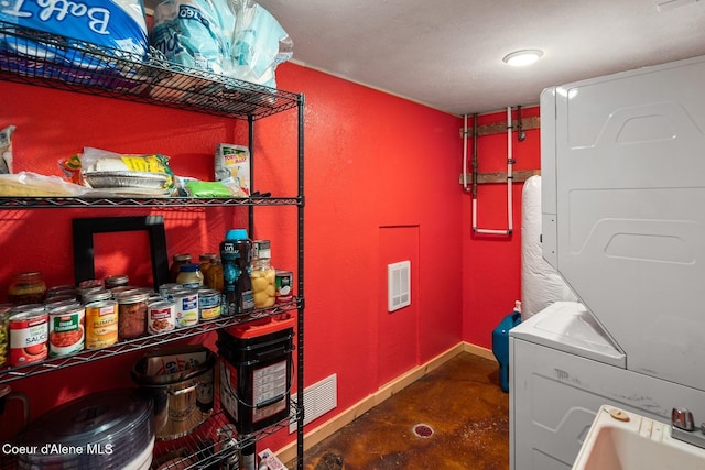 26443 S Farup Rd, Worley, ID 83876 - washroom with stacked washer / dryer and baseboards