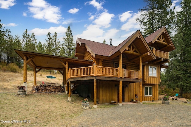 26443 S Farup Rd, Worley, ID 83876 - rear view of property featuring board and batten siding, a shingled roof, a wooden deck, and log exterior