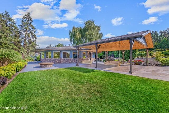 822 Ridgewood, Kamiah, ID 83536 - back of house featuring a patio, a yard, and stone siding