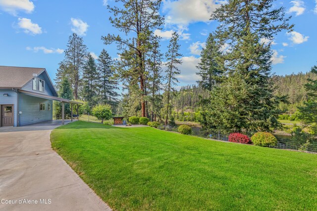 822 Ridgewood, Kamiah, ID 83536 - view of yard featuring concrete driveway and a carport