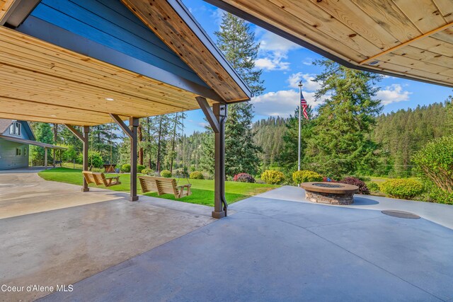 822 Ridgewood, Kamiah, ID 83536 - view of patio / terrace with a fire pit and a forest view