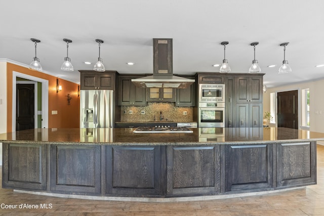 822 Ridgewood, Kamiah, ID 83536 - kitchen with appliances with stainless steel finishes, island range hood, decorative backsplash, recessed lighting, and a large island