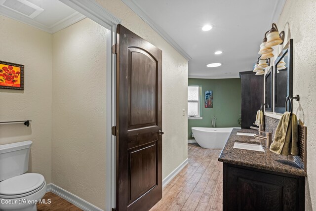 822 Ridgewood, Kamiah, ID 83536 - full bath with crown molding, a freestanding tub, wood-type flooring, double vanity, and recessed lighting