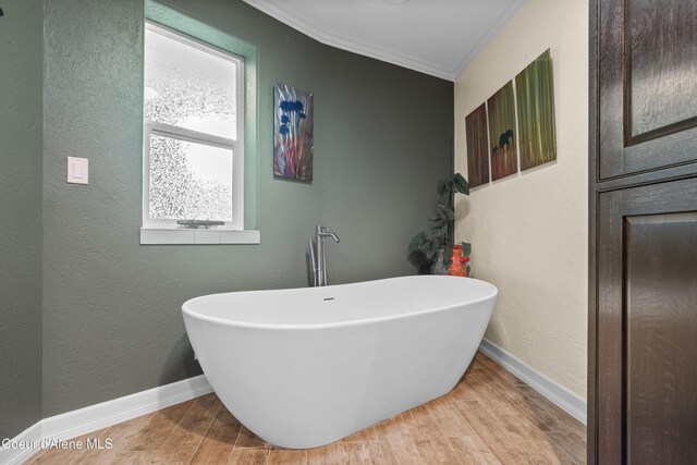 822 Ridgewood, Kamiah, ID 83536 - bathroom with a freestanding tub, ornamental molding, wood finished floors, and a textured wall