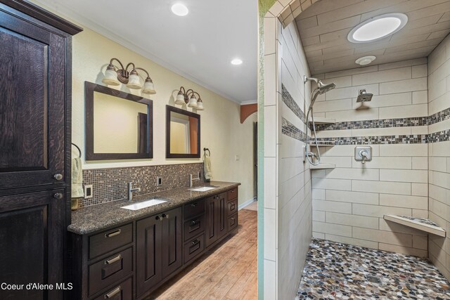 822 Ridgewood, Kamiah, ID 83536 - full bath featuring ornamental molding, double vanity, tiled shower, decorative backsplash, and wood finished floors
