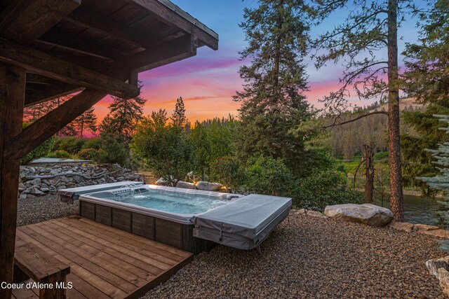 822 Ridgewood, Kamiah, ID 83536 - pool at dusk featuring an outdoor hot tub