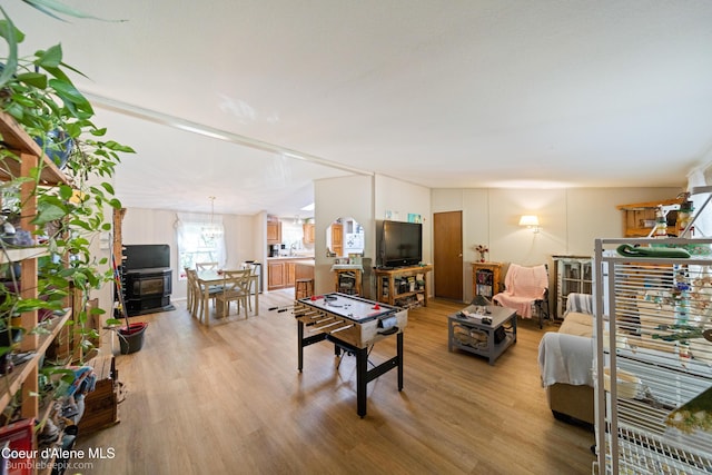 221 E 4th St, Oldtown, ID 83822 - living room featuring light wood-style floors and a chandelier