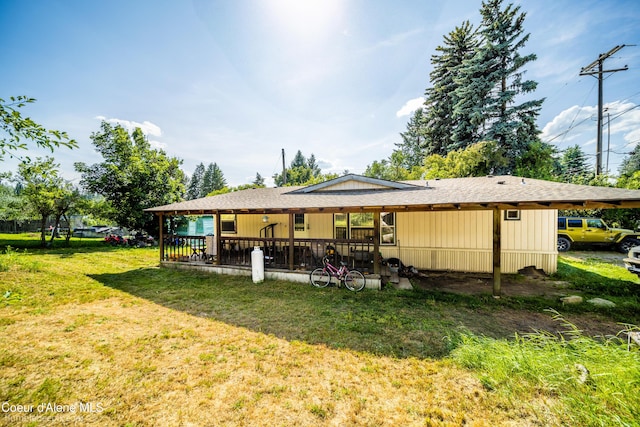221 E 4th St, Oldtown, ID 83822 - back of property with a yard and roof with shingles
