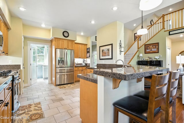 30 Beacon Hill Rd, Cocolalla, ID 83813 - kitchen with stainless steel appliances, a breakfast bar area, recessed lighting, pendant lighting, and light tile patterned floors