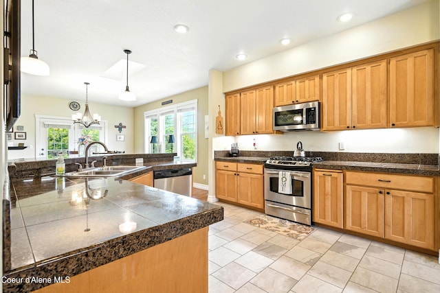 30 Beacon Hill Rd, Cocolalla, ID 83813 - kitchen with appliances with stainless steel finishes, recessed lighting, tile countertops, pendant lighting, and a chandelier