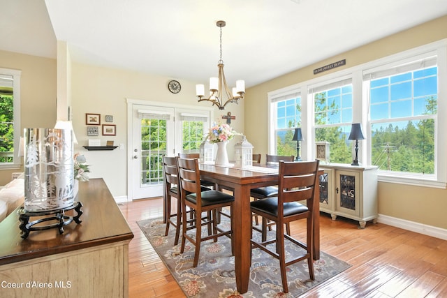 30 Beacon Hill Rd, Cocolalla, ID 83813 - dining space featuring a chandelier, plenty of natural light, and light wood-style flooring