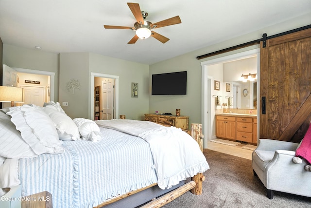 30 Beacon Hill Rd, Cocolalla, ID 83813 - carpeted bedroom with a barn door, connected bathroom, and ceiling fan