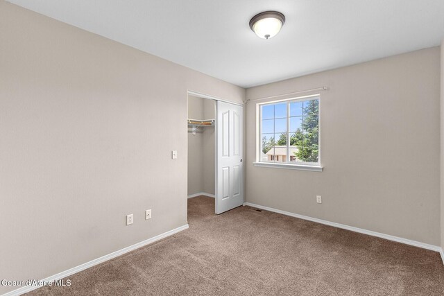 14106 N Lauren Loop, Rathdrum, ID 83858 - unfurnished bedroom featuring carpet and a closet