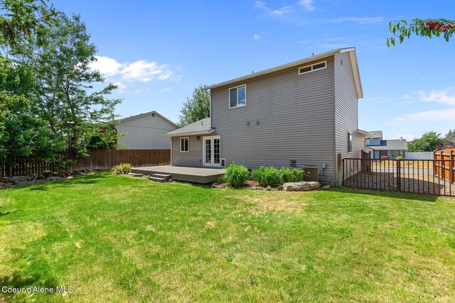14106 N Lauren Loop, Rathdrum, ID 83858 - back of house with a fenced backyard, french doors, and a deck