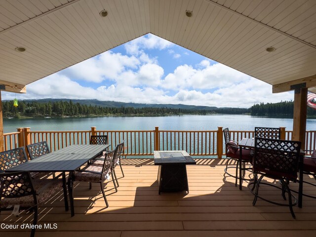 1349 Lakeshore Dr, Libby, MT 59923 - dock area with outdoor dining space, a deck with water view, and an outdoor fire pit