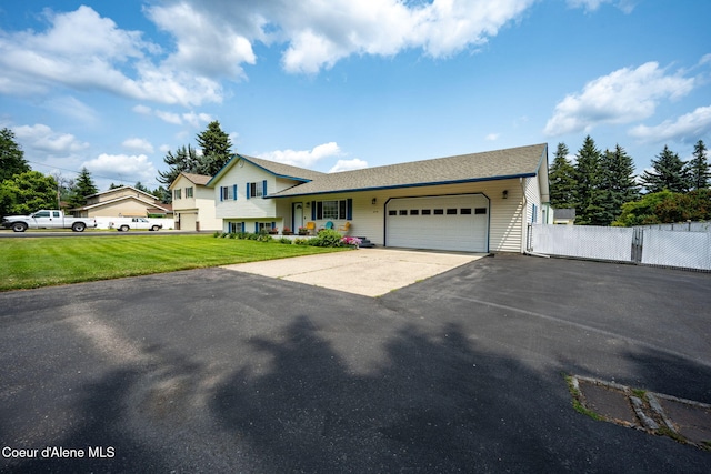 9270 N Maple St, Hayden, ID 83835 - split level home featuring a garage and asphalt driveway