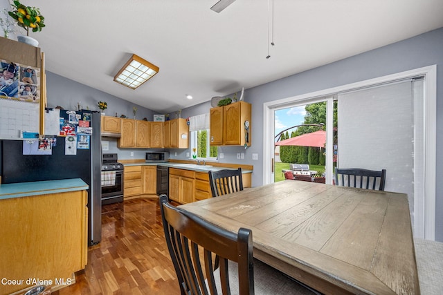 9270 N Maple St, Hayden, ID 83835 - kitchen with freestanding refrigerator, dark wood finished floors, stainless steel gas range, light countertops, and vaulted ceiling