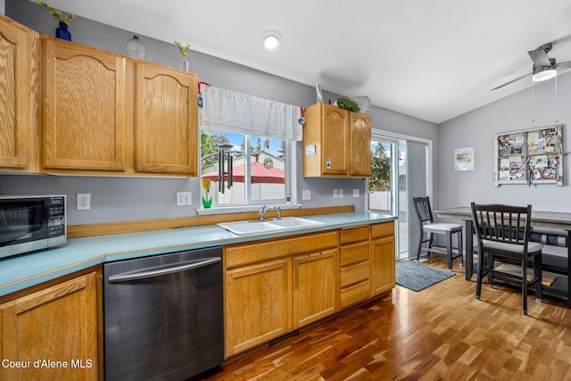9270 N Maple St, Hayden, ID 83835 - kitchen with stainless steel dishwasher, dark wood finished floors, vaulted ceiling, light countertops, and a ceiling fan