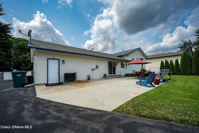 9270 N Maple St, Hayden, ID 83835 - back of house featuring a lawn and a patio