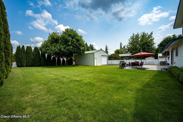 9270 N Maple St, Hayden, ID 83835 - view of yard featuring a garage, an outbuilding, and a patio area