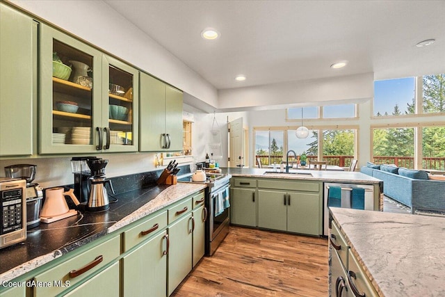 6101 Bottle Bay Rd, Sagle, ID 83860 - kitchen featuring green cabinets, stainless steel range oven, light wood finished floors, recessed lighting, and black microwave