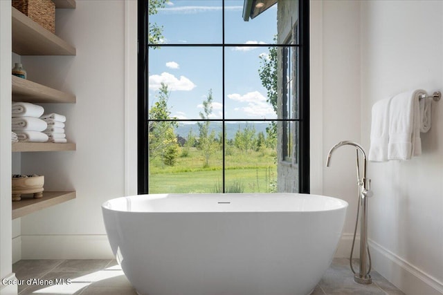 960 Golden Thread Ct, Driggs, ID 83422 - bathroom featuring tile patterned floors, a freestanding bath, and plenty of natural light