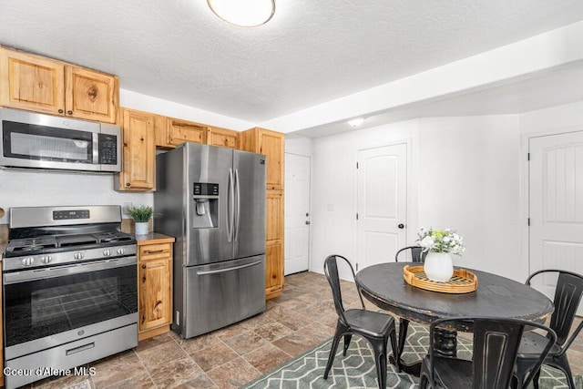 606 Residence St, Wallace, ID 83873 - kitchen with stainless steel appliances and stone finish floors
