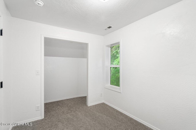 606 Residence St, Wallace, ID 83873 - unfurnished bedroom with carpet flooring and a textured ceiling