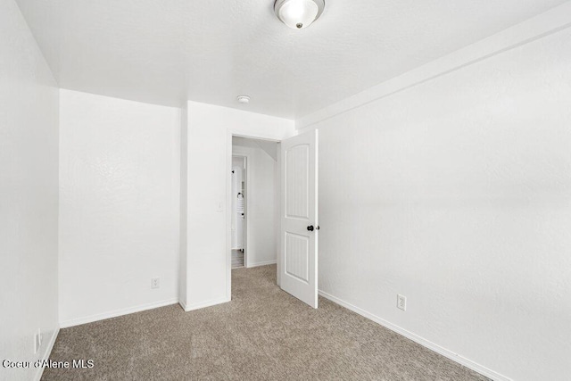 606 Residence St, Wallace, ID 83873 - carpeted spare room featuring baseboards and a smoke detector
