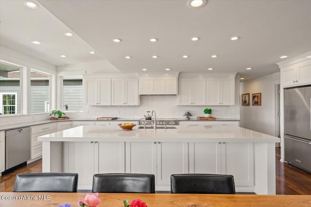6744 E Greta Ave, Post Falls, ID 83854 - kitchen with stainless steel appliances, white cabinets, light countertops, dark wood finished floors, and recessed lighting