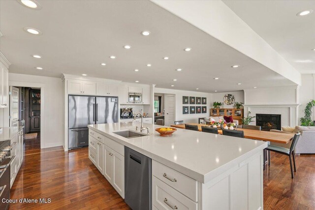 6744 E Greta Ave, Post Falls, ID 83854 - kitchen featuring stainless steel appliances, recessed lighting, dark wood-style flooring, white cabinets, and light countertops