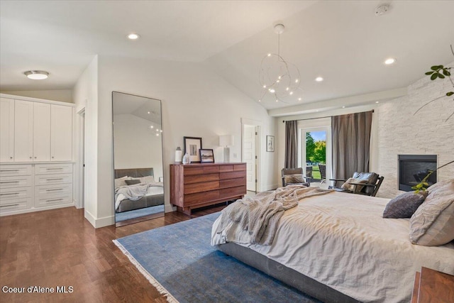 6744 E Greta Ave, Post Falls, ID 83854 - bedroom featuring vaulted ceiling, dark wood finished floors, access to outside, a fireplace, and a chandelier