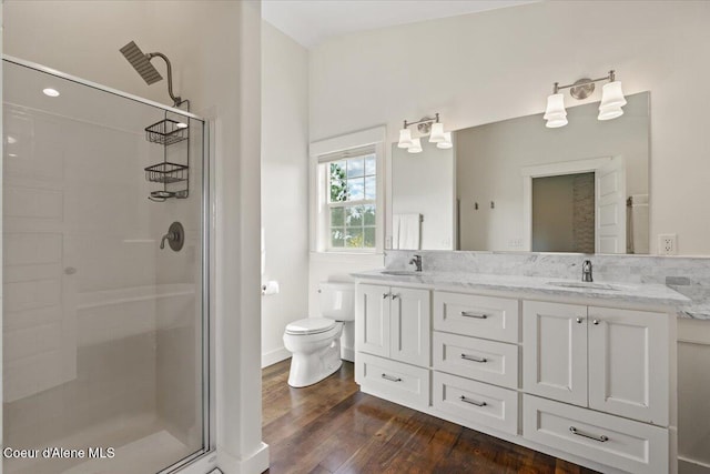 6744 E Greta Ave, Post Falls, ID 83854 - full bath featuring a shower stall, double vanity, and wood finished floors