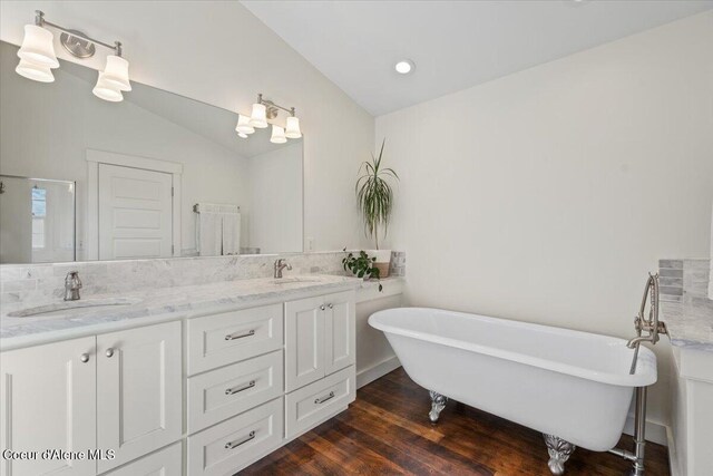 6744 E Greta Ave, Post Falls, ID 83854 - bathroom featuring double vanity, a freestanding tub, wood finished floors, and recessed lighting