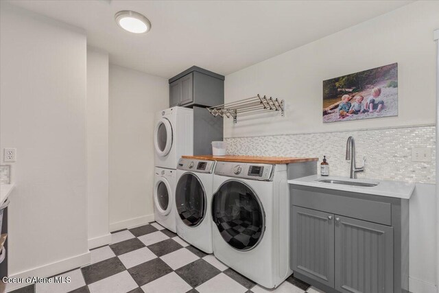 6744 E Greta Ave, Post Falls, ID 83854 - laundry room with light floors, cabinet space, and washing machine and clothes dryer