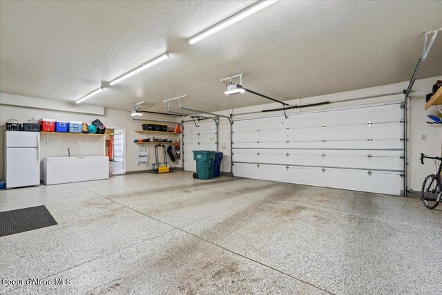 6744 E Greta Ave, Post Falls, ID 83854 - garage with freestanding refrigerator and a garage door opener
