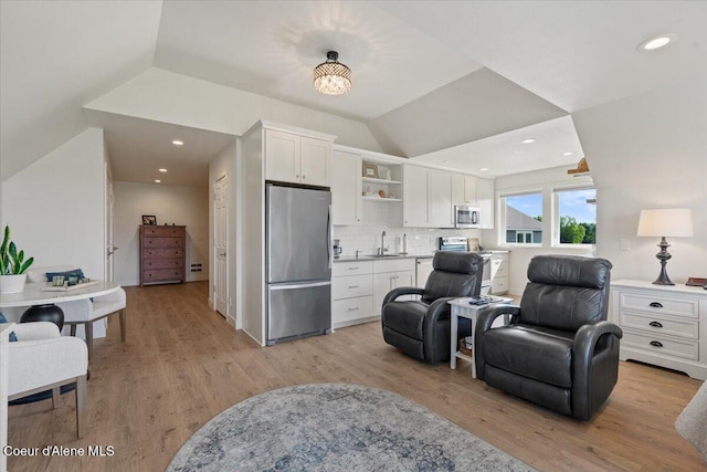 6744 E Greta Ave, Post Falls, ID 83854 - kitchen featuring appliances with stainless steel finishes, open floor plan, white cabinets, open shelves, and light wood-style flooring