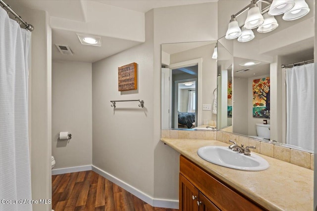 6744 E Greta Ave, Post Falls, ID 83854 - ensuite bathroom with wood finished floors, vanity, and a shower with curtain