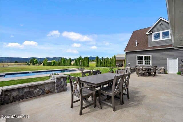 6744 E Greta Ave, Post Falls, ID 83854 - view of patio featuring outdoor dining area, an outdoor pool, and a water and mountain view