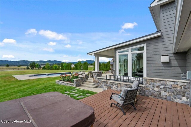 6744 E Greta Ave, Post Falls, ID 83854 - deck with a mountain view, an outdoor pool, a lawn, and a patio