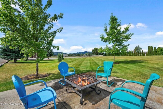 6744 E Greta Ave, Post Falls, ID 83854 - view of patio / terrace with a fire pit and a mountain view