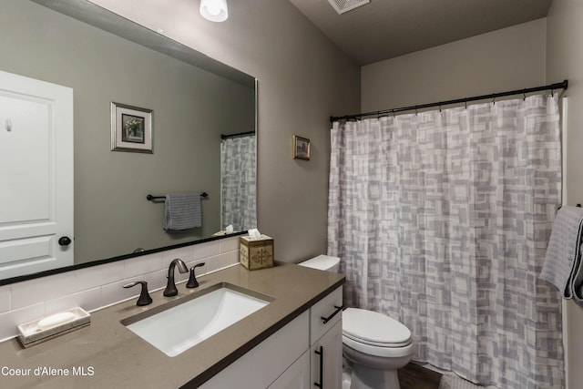 4574 N Connery Loop, Post Falls, ID 83854 - full bathroom with vanity, decorative backsplash, and curtained shower