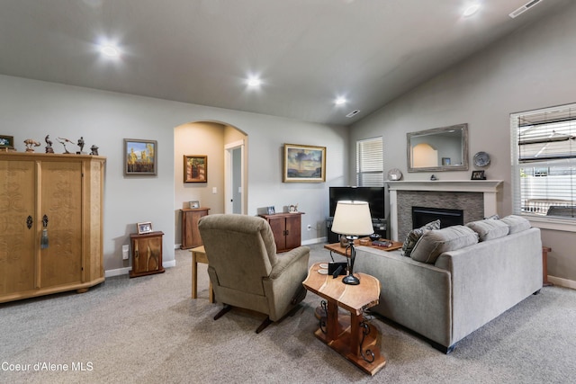 4574 N Connery Loop, Post Falls, ID 83854 - living room with arched walkways, a fireplace, vaulted ceiling, light colored carpet, and recessed lighting