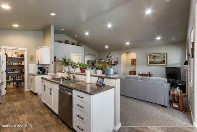 4574 N Connery Loop, Post Falls, ID 83854 - kitchen with stainless steel dishwasher, open floor plan, arched walkways, a center island with sink, and vaulted ceiling