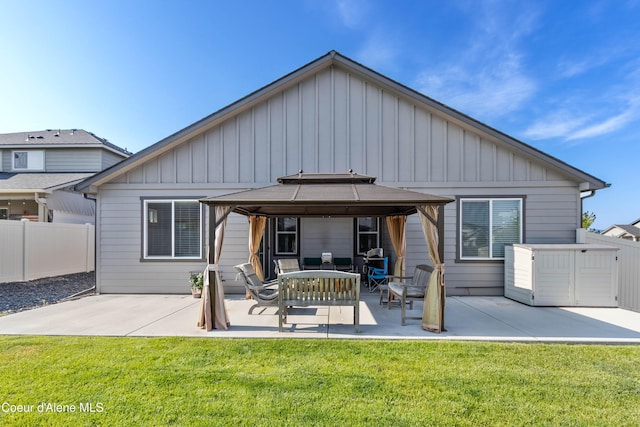 4574 N Connery Loop, Post Falls, ID 83854 - rear view of house featuring a gazebo, board and batten siding, a patio area, and a fenced backyard