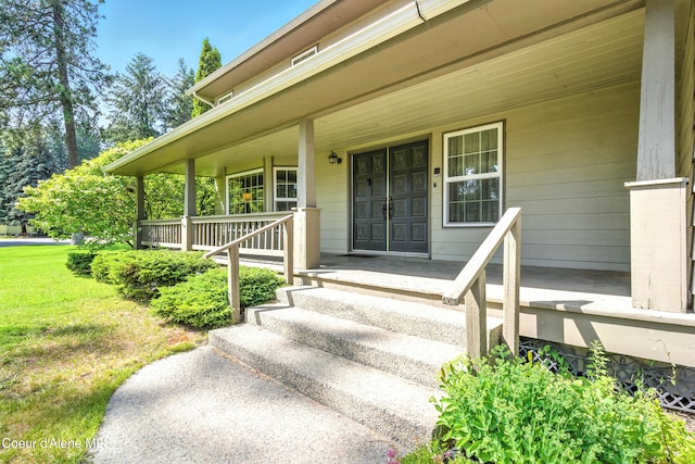 5678 N Pinegrove Dr, Coeur Dalene, ID 83815 - property entrance featuring covered porch and a yard