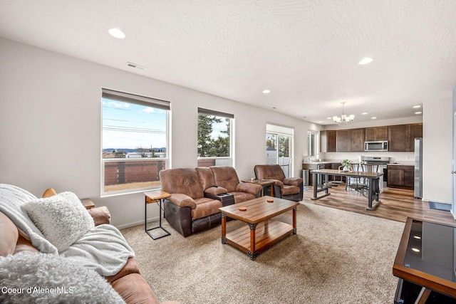 3664 W Belgrave Way, Hayden, ID 83835 - living area with a chandelier, recessed lighting, and a textured ceiling