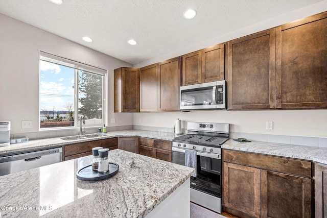3664 W Belgrave Way, Hayden, ID 83835 - kitchen with stainless steel appliances, recessed lighting, and light stone counters